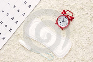 Sanitary menstruation pad for woman menstrual period. Red clock