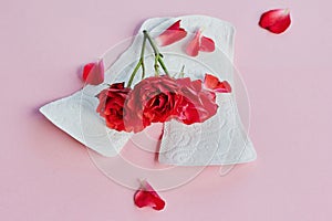 Sanitary napkin and flower on pastel pink background