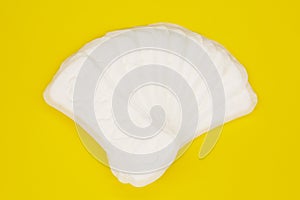 Sanitary napkin or sanitary pad for intimate hygiene on a yellow background