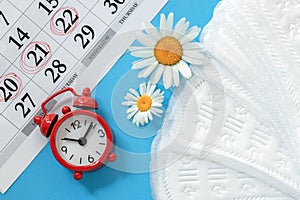 Sanitary napkins, alarm clock and calendar