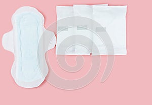 Sanitary pads and absorbent sheets on a pink background