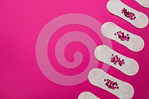 Sanitary pads with sequins on pink background, flat lay and space for text. Menstrual cycle