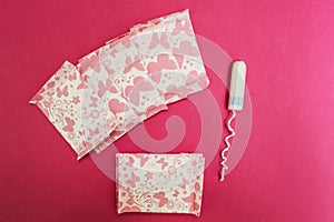 Sanitary pads and tampon on a pink background