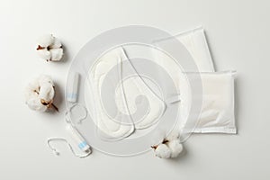 Sanitary pads, tampons and cotton on white background