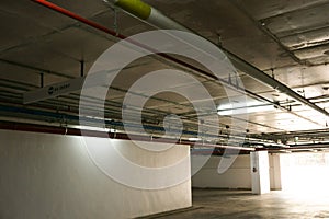 Sanitary system pipes and electrical cables installed under flat slab reinforced concrete structure in building.Ventilation pipes