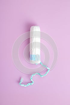 Sanitary tampon isolated on pink background. Beauty and hygiene concept