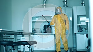 Sanitation inspector is spraying chemicals in the laboratory