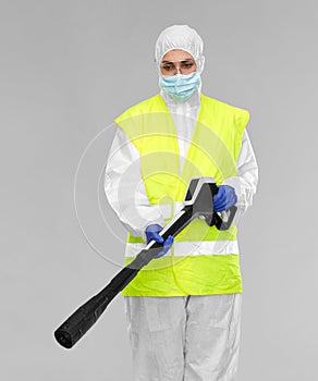 Sanitation worker in hazmat with pressure washer