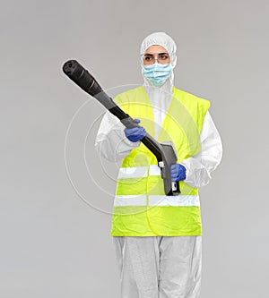 Sanitation worker in hazmat with pressure washer