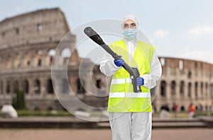 Sanitation worker in hazmat with pressure washer