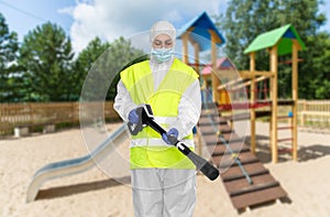 Sanitation worker in hazmat with pressure washer