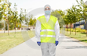 Sanitation worker in hazmat with pressure washer