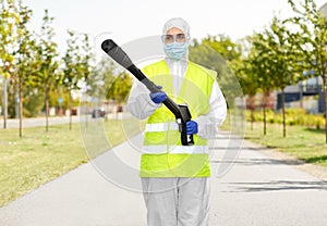 Sanitation worker in hazmat with pressure washer