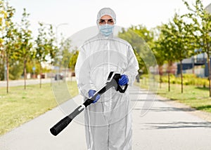 Sanitation worker in hazmat with pressure washer