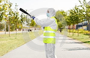 Sanitation worker in hazmat with pressure washer