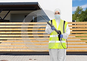 Sanitation worker in hazmat with pressure washer