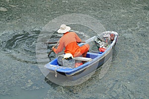 Sanitation workers clean up the rubbish in the river photo