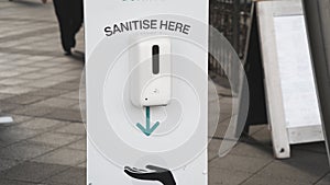 Sanitise hands dispenser in a shopping centre photo