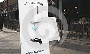 Sanitise hands dispenser in a shopping centre photo