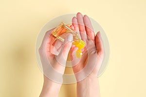 Sanitizer bottle in female hands. Woman applying antibacterial gel. Coronavirus Disease Covid-19 prevention and health