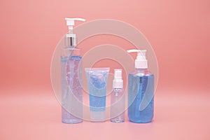 sanitizer gel pump dispenser. Clear sanitizer in pump bottle, for killing germs, bacteria and virus. isolate on Pink background photo