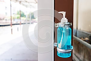 Sanitizer liquid for disinfection in a bottle attached to a post on the street. Covid pandemic virus Sanitation facilities in big