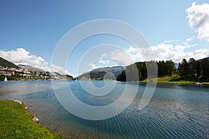 Sankt Moritz blue lake, clean water and sail boats in a sunny day in Switzerland