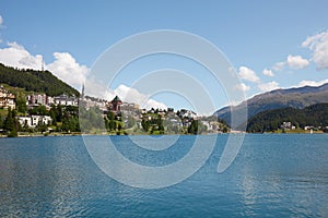 Sankt Moritz town and blue lake in a sunny summer day in Switzerland photo