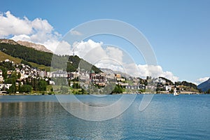 Sankt Moritz town, lake and sail boat in a sunny summer day in Switzerland photo