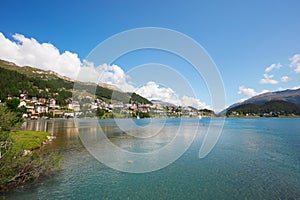 Sankt Moritz town and lake with transparent water in a sunny day in Switzerland photo