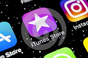 Apple iTunes store application icon on Apple iPhone X smartphone screen close-up. Mobile application icon of itunes store. Social