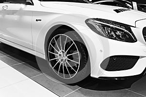 Front view of a Mercedes Benz C 43 AMG 4matic Bi-turbo 2018. Headlight system. Car exterior details. Black and white.