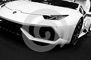 Front view of a White Luxury sport car Lamborghini Huracan LP 610-4. Car exterior details. Black and white