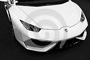 Front view of a White Luxury sport car Lamborghini Huracan LP 610-4. Car exterior details. Black and white.