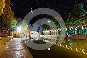 Sanli Urfa, Turkey: September 12 2020:  Halil-ur Rahman Mosque and Holy lake in Golbasi Park at night under crescent and stars