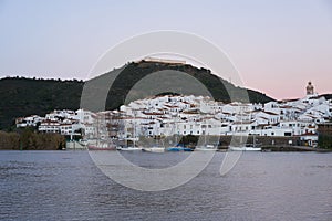 Sanlucar de Guadiana in Spain and Alcoutim in Portugal with sail boats on Guadiana river