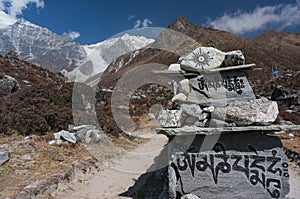 Sanskrit mantra rock carving leading Langtang Lirung photo