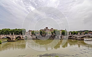 Sant\' Angelo and Vittorio Emanuele II bridges on Tiber river panoramic view under impressive sky. photo