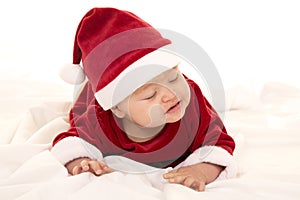 Santa baby lay on belly eyes closed