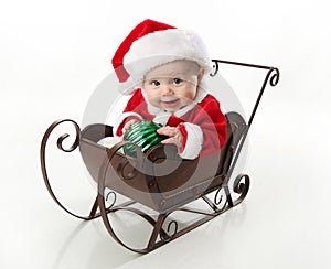 Santa baby sitting in a sleigh photo