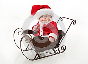 Santa baby sitting in a sleigh