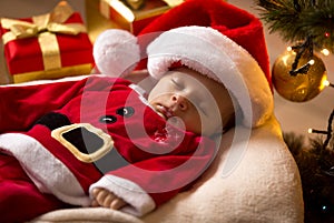 Santa baby sleeping with Christmas presents at living room