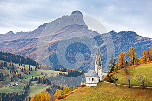 Santa Barbara church at the autumn Dolomite Alps