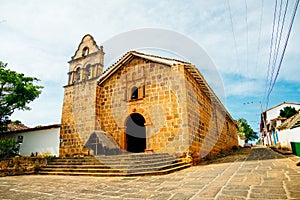 Santa Barbara church and stone cross in the colonial town of Barichara, Colombia