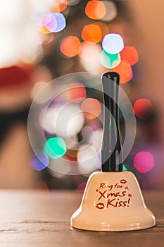 Santa bell with Christmas lights and children in the background