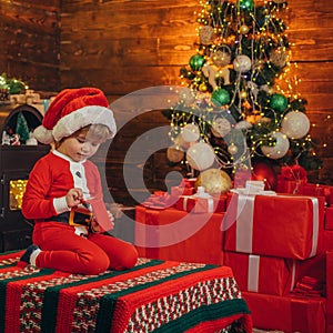 Santa boy little child celebrate christmas at home. Childhood memories. Family holiday. Boy cute child cheerful mood