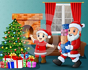 Santa bringing gift box and kid in the living room with christmas and new year decoration