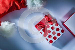 Santa cap wrapped present box on white surface