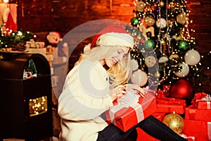 From Santa. cheerful girl red santa hat. xmas holiday gift. Decorate christmas tree. happy woman love presents. Winter