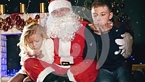 Santa and children around the decorated Christmas tree. Wishes